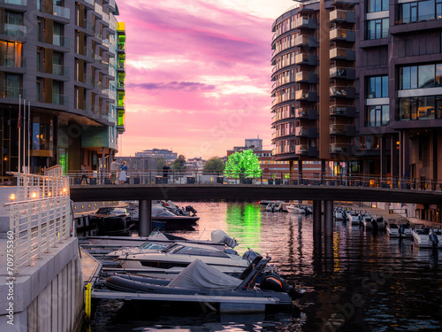 Canal with moored boats in Aker Brygge neighbourhood in Oslo, Norway. Typical example of Scandinavian architecture in the Aker Brygge area in Oslo photo