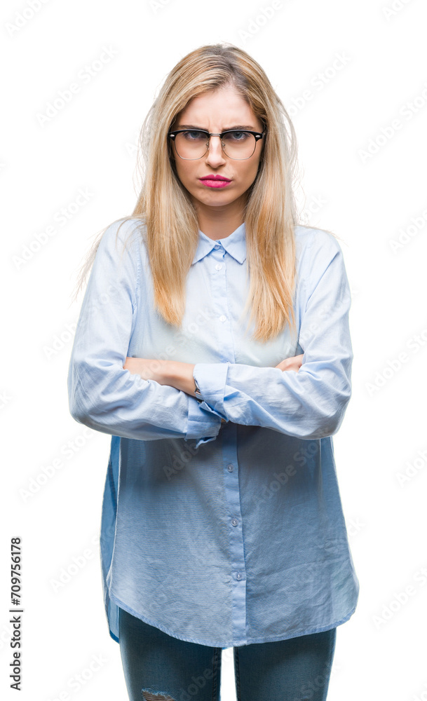 Young beautiful blonde business woman wearing glasses over isolated background skeptic and nervous, disapproving expression on face with crossed arms. Negative person.