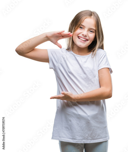 Young beautiful girl over isolated background gesturing with hands showing big and large size sign, measure symbol. Smiling looking at the camera. Measuring concept.