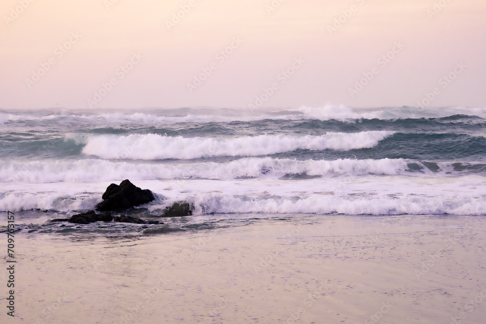 Fototapeta premium Sunset with waves crashing against the rocks. Finisterre, Costa da Morte, Galicia, Spain