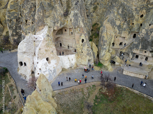 View of the Goreme Open Air Museum in Cappadocia, Turkey. This Unesco World Heritage site is an essential stop on any Cappadocian itinerary. Tourists visiting the historical site.