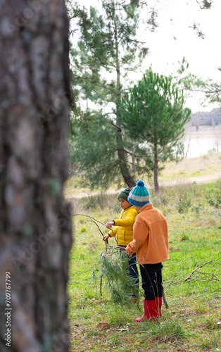 Two children playing in a forest with elements of nature