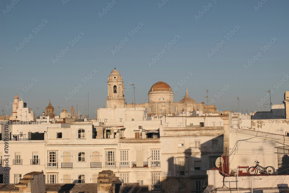 Aerial panoramic view of the old city rooftops, Mercado Central and Cathedral de Santa Cruz in summer evening sunset light. Beautiful historic Cadiz town. Travel Europe, Andalusia, Spain.