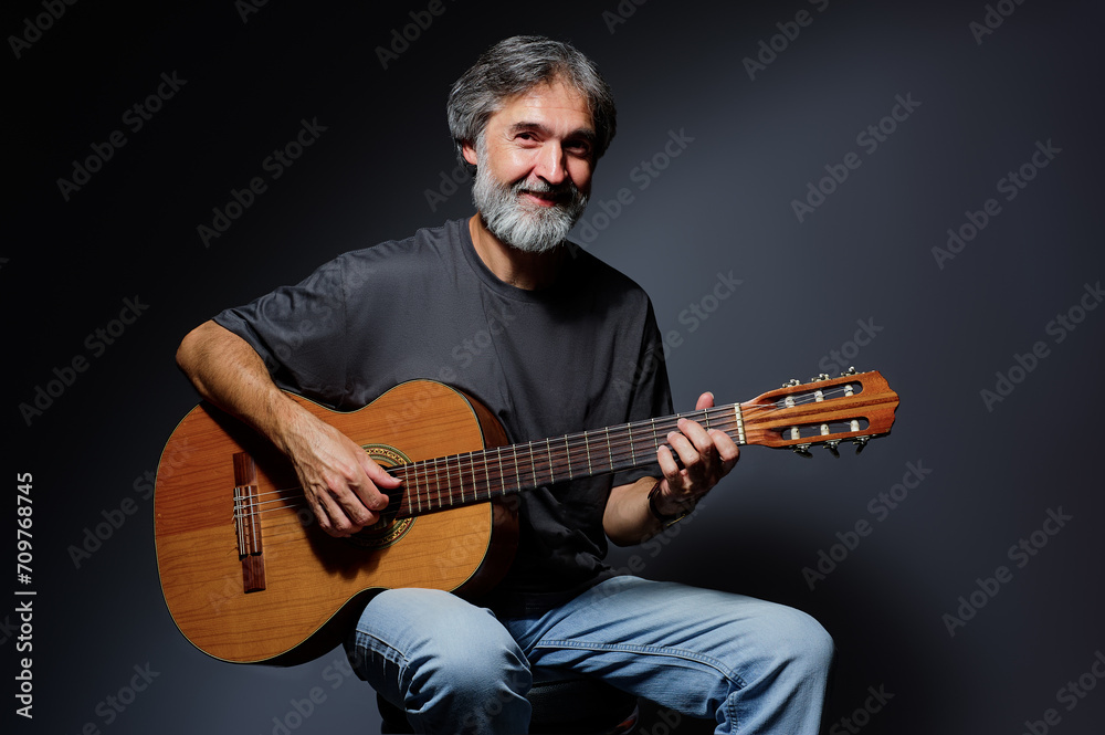 © luengo_ua - Aged bearded man with an acoustic guitar © luengo_ua - Aged bearded man with an acoustic guitar