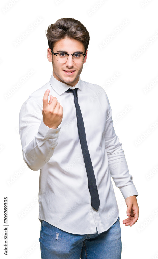 Young business man wearing glasses over isolated background Beckoning come here gesture with hand inviting happy and smiling Young business man wearing glasses over isolated background Beckoning come here gesture with hand inviting happy and smiling