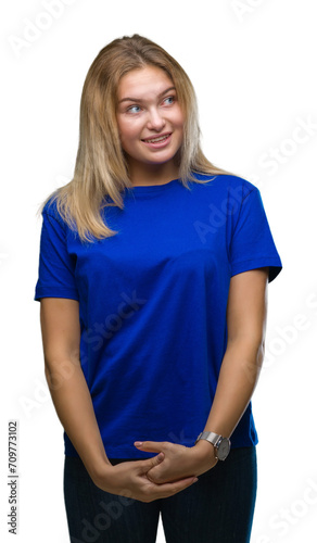 Young caucasian woman over isolated background looking away to side with smile on face, natural expression. Laughing confident.