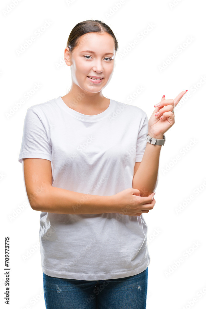 Young beautiful caucasian woman over isolated background with a big smile on face, pointing with hand and finger to the side looking at the camera. Young beautiful caucasian woman over isolated background with a big smile on face, pointing with hand and finger to the side looking at the camera.