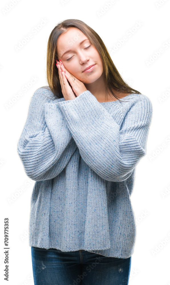 Young beautiful caucasian woman wearing winter sweater over isolated background sleeping tired dreaming and posing with hands together while smiling with closed eyes. Young beautiful caucasian woman wearing winter sweater over isolated background sleeping tired dreaming and posing with hands together while smiling with closed eyes.