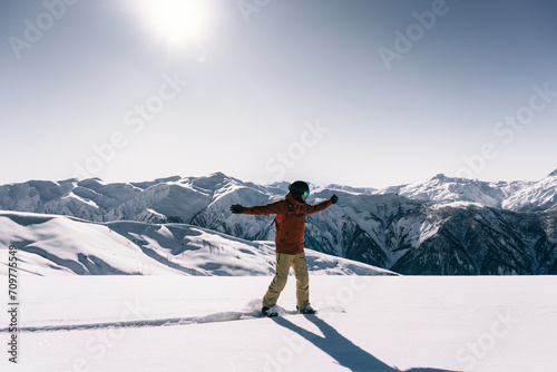 snowboarder freerider riding on an unprepared snow field on board in high mountains