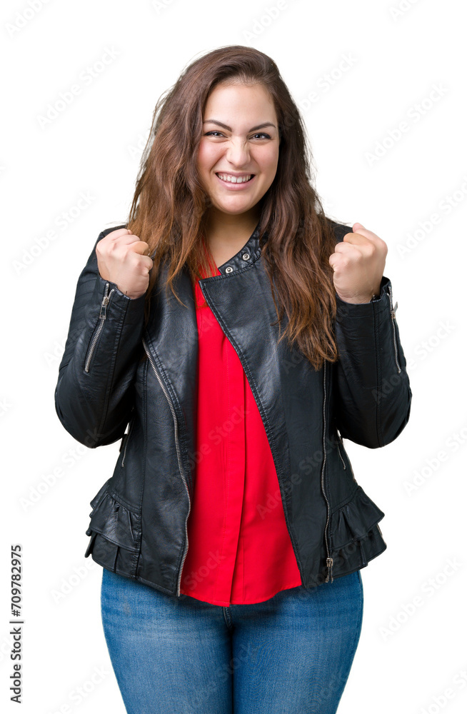 Beautiful plus size young woman wearing a fashion leather jacket over isolated background excited for success with arms raised celebrating victory smiling. Winner concept. Beautiful plus size young woman wearing a fashion leather jacket over isolated background excited for success with arms raised celebrating victory smiling. Winner concept.