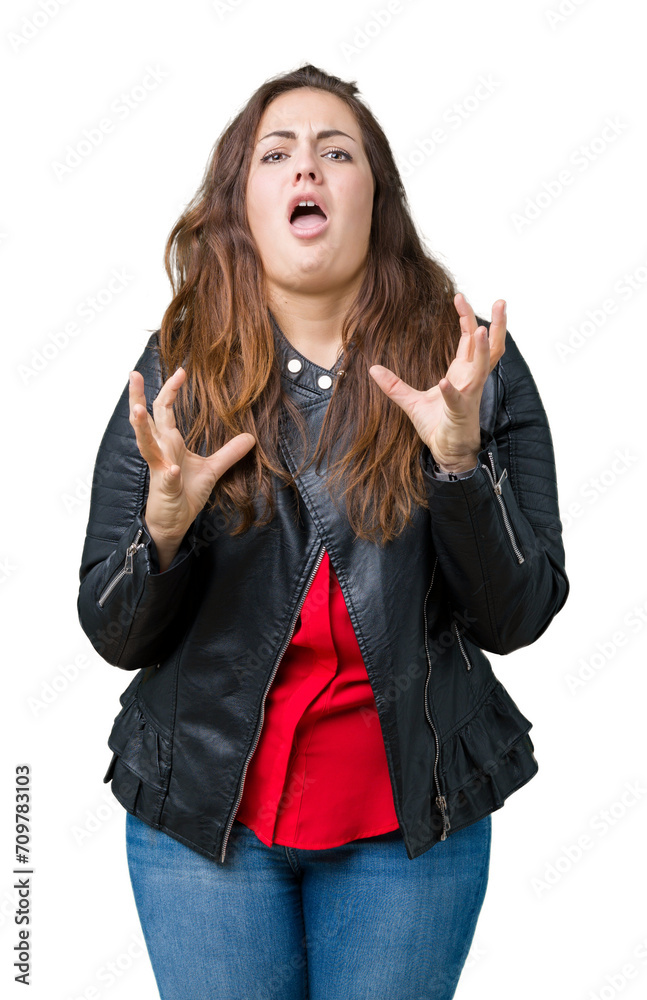 Beautiful plus size young woman wearing a fashion leather jacket over isolated background crazy and mad shouting and yelling with aggressive expression and arms raised. Frustration concept. Beautiful plus size young woman wearing a fashion leather jacket over isolated background crazy and mad shouting and yelling with aggressive expression and arms raised. Frustration concept.
