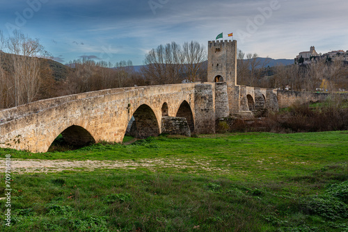 Medieval Bridge of Frías over the Ebro River and Church of San Vicente in the background, Burgos, Castilla y León, Spain.