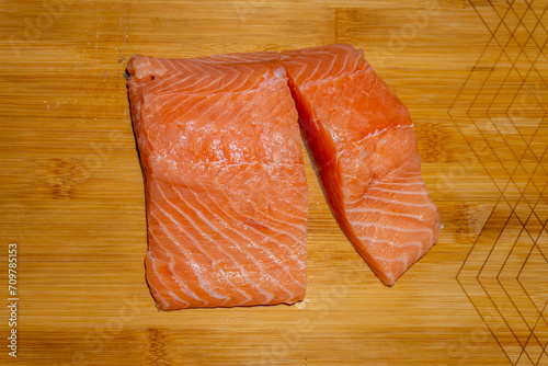Fresh raw salmon fillet on wooden cutting board