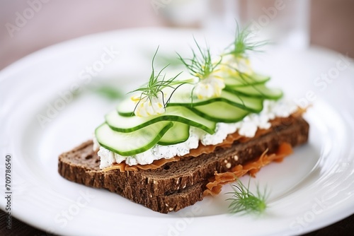 rye bread with cottage cheese and sliced cucumber photo