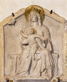 TREVISO, ITALY - NOVEMBER 8, 2023: The relief of Madonna with the Jesus child and butterfly (symbol of the soul) in church Chiesa di San Vito e Santa Lucia probably by Filippo Calendario (14. cent).