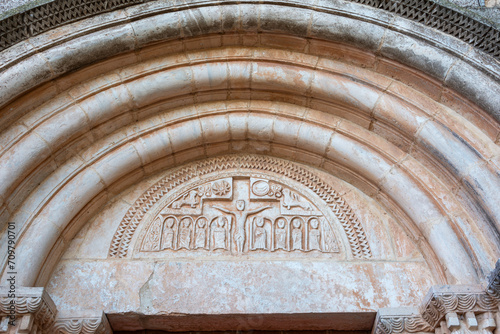 View of the tympanum, lintel and archivolts of the Romanesque church of Santa María in Siurana in Tarragona, Spain, horizontal photo