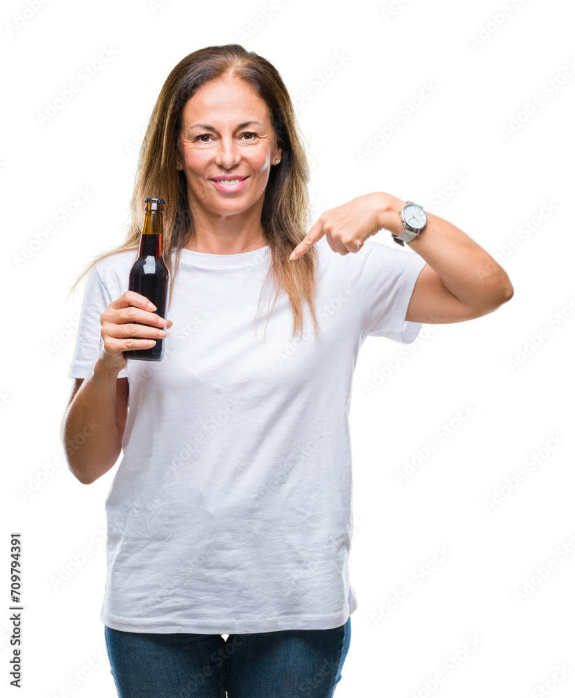 Middle age hispanic woman drinking beer over isolated background with surprise face pointing finger to himself