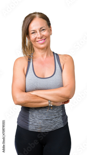Beautiful middle age woman wearing sport clothes over isolated background happy face smiling with crossed arms looking at the camera. Positive person. © Krakenimages.com