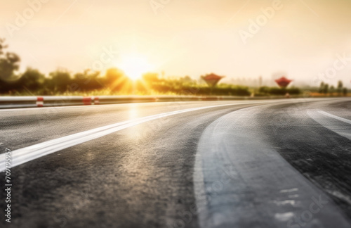 Asphalt highway with beautiful view of sunset and clouds © Riz
