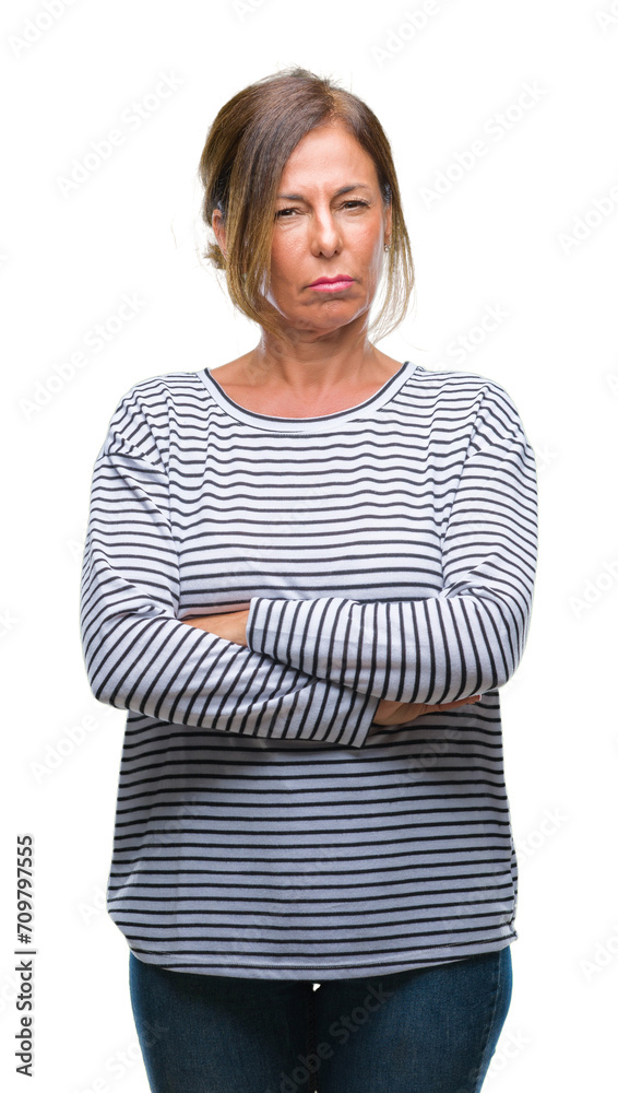 Middle age senior hispanic woman over isolated background skeptic and nervous, disapproving expression on face with crossed arms. Negative person. Middle age senior hispanic woman over isolated background skeptic and nervous, disapproving expression on face with crossed arms. Negative person.