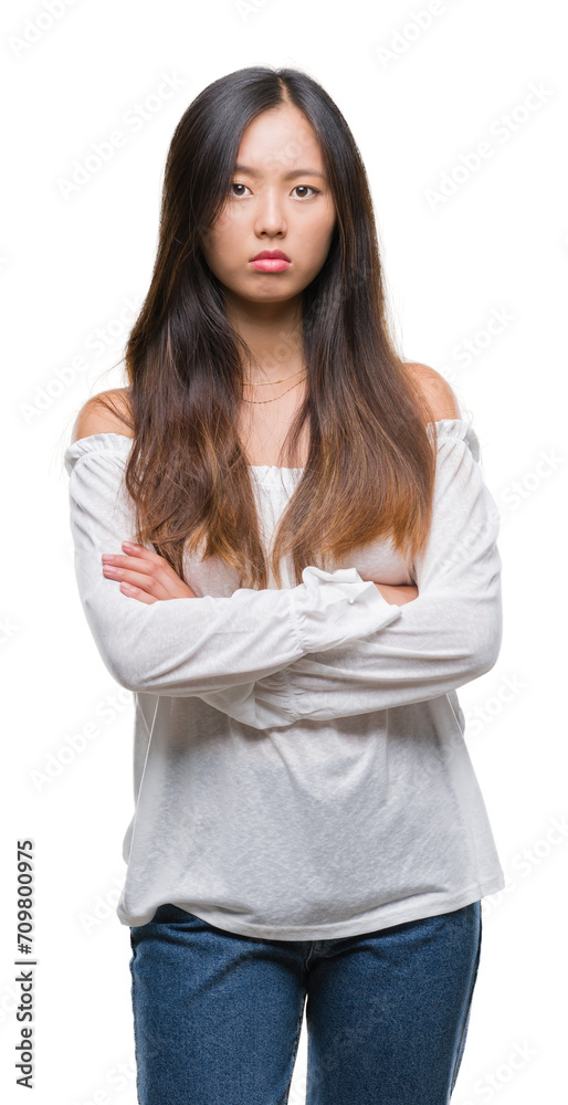 Young asian woman over isolated background skeptic and nervous, disapproving expression on face with crossed arms. Negative person. Young asian woman over isolated background skeptic and nervous, disapproving expression on face with crossed arms. Negative person.