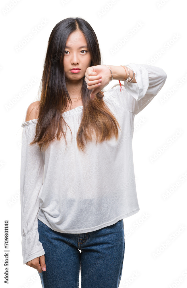 Young asian woman over isolated background looking unhappy and angry showing rejection and negative with thumbs down gesture. Bad expression. Young asian woman over isolated background looking unhappy and angry showing rejection and negative with thumbs down gesture. Bad expression.