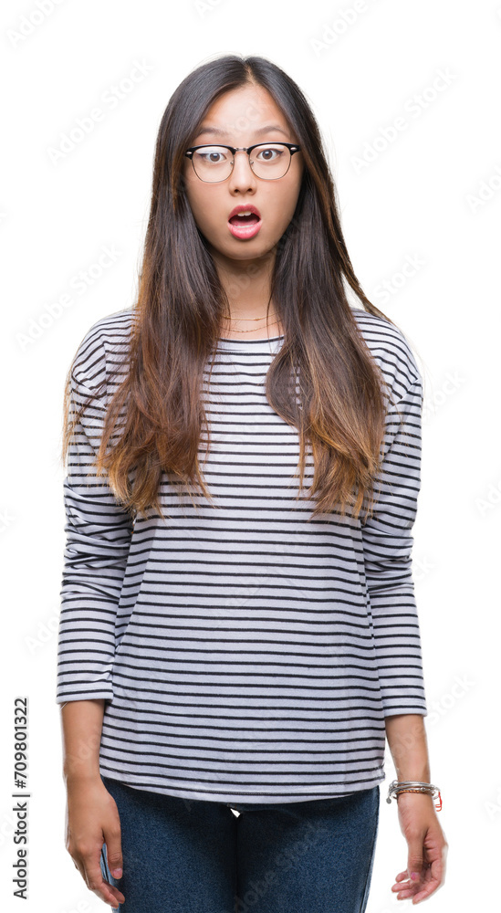 Young asian woman wearing glasses over isolated background afraid and shocked with surprise expression, fear and excited face. Young asian woman wearing glasses over isolated background afraid and shocked with surprise expression, fear and excited face.