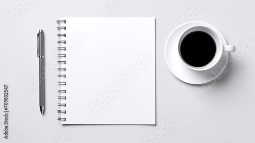 Stationery  a single-color table with a notebook for notes  a stylish pen and a mug with tea and coffee. Image for advertising and presentation of office products. Gray background. Top down view.