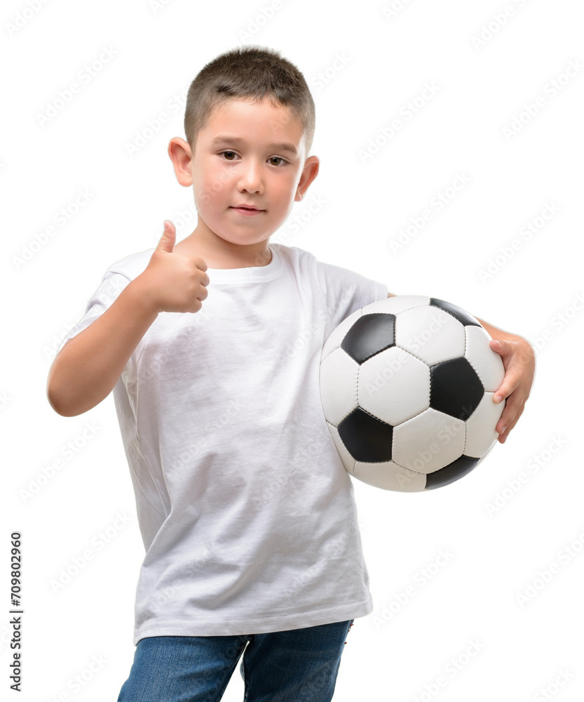 Dark haired little child playing with soccer ball happy with big smile doing ok sign, thumb up with fingers, excellent sign