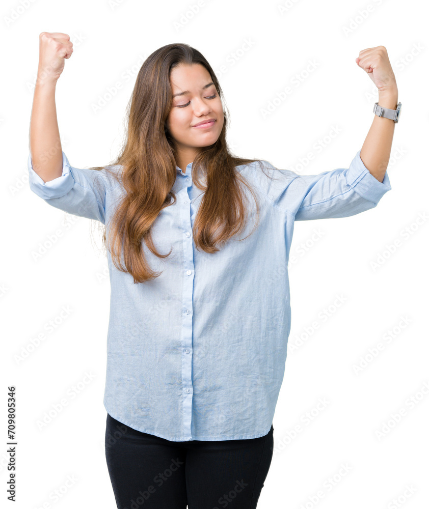 Young beautiful brunette business woman over isolated background showing arms muscles smiling proud. Fitness concept. Young beautiful brunette business woman over isolated background showing arms muscles smiling proud. Fitness concept.