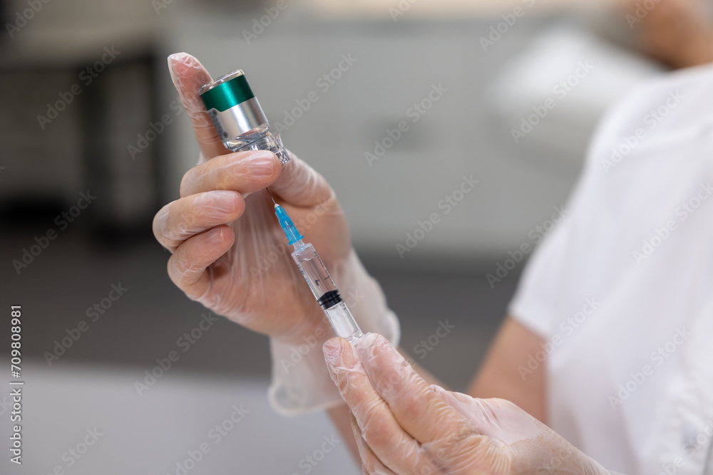 Beautician preparing beauty injections for female patient Beautician preparing beauty injections for female patient