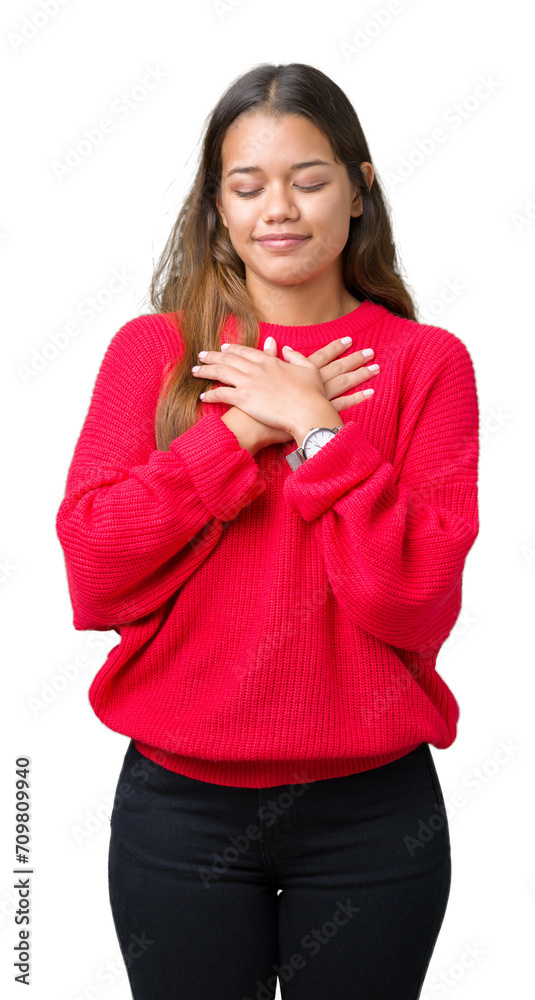 Young beautiful brunette woman wearing red winter sweater over isolated background smiling with hands on chest with closed eyes and grateful gesture on face. Health concept. Young beautiful brunette woman wearing red winter sweater over isolated background smiling with hands on chest with closed eyes and grateful gesture on face. Health concept.