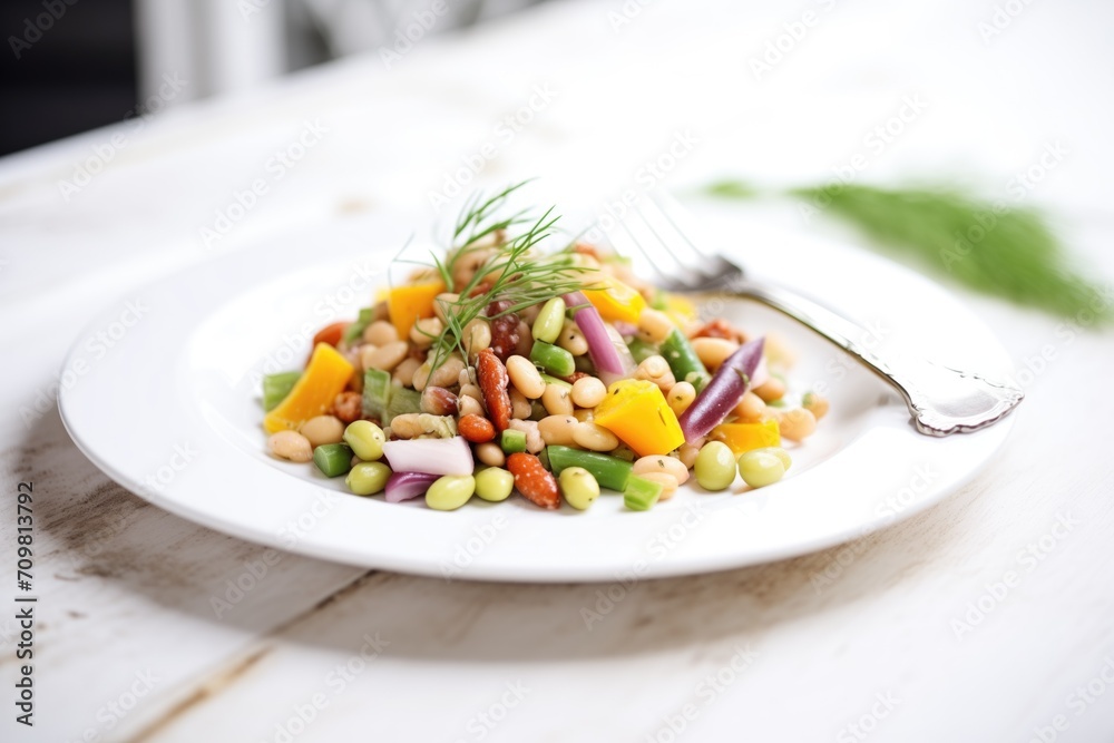three bean salad on a white plate with silver fork three bean salad on a white plate with silver fork