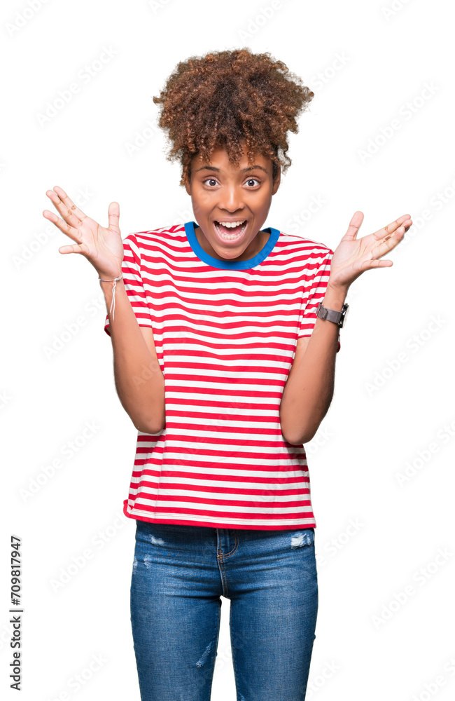 Beautiful young african american woman over isolated background celebrating crazy and amazed for success with arms raised and open eyes screaming excited. Winner concept Beautiful young african american woman over isolated background celebrating crazy and amazed for success with arms raised and open eyes screaming excited. Winner concept