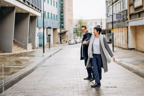 Handsome man and beautiful woman hugging each other as they walk around city, having fun time, lifstyle photo