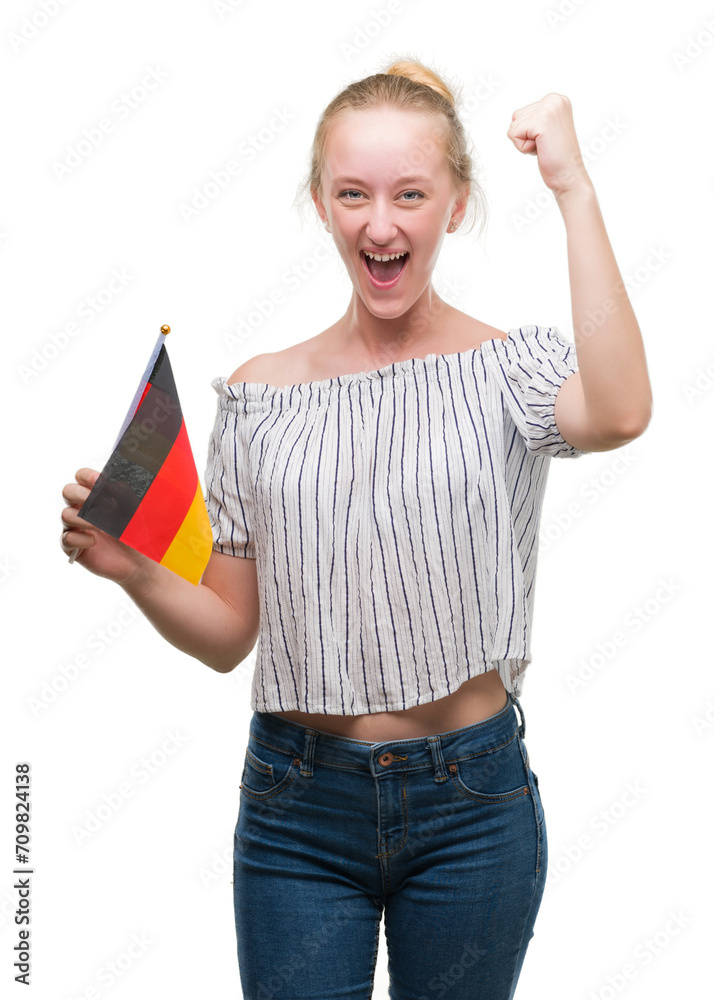 Blonde teenager woman holding flag of Germany annoyed and frustrated shouting with anger, crazy and yelling with raised hand, anger concept