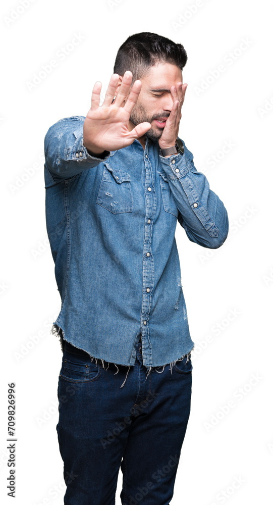 Young handsome man over isolated background covering eyes with hands and doing stop gesture with sad and fear expression. Embarrassed and negative concept. Young handsome man over isolated background covering eyes with hands and doing stop gesture with sad and fear expression. Embarrassed and negative concept.