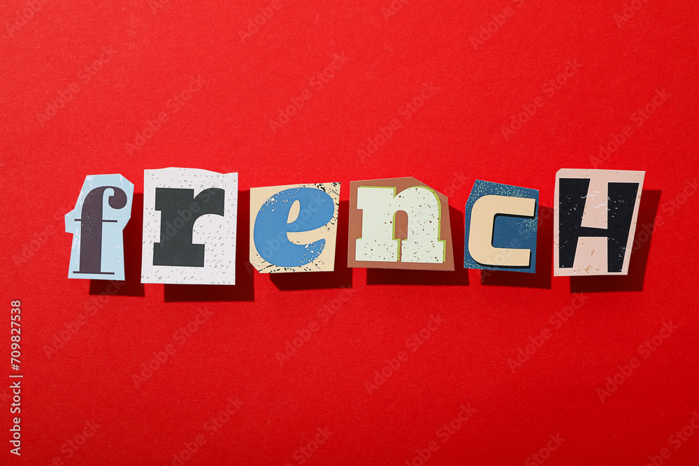 Obraz premium The word French on a red background, top view.