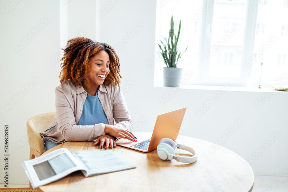 Young African American woman is working on a laptop. Young African American woman is working on a laptop.