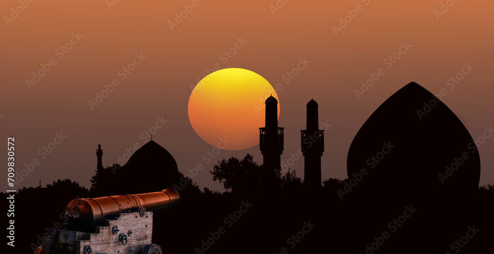 Ramadan Concept - Ramadan kareem cannon with silhouette of mosque in the background  