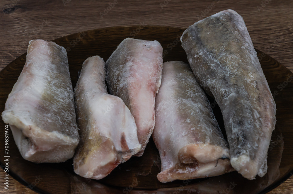 Frozen hake fish carcass on a plate Frozen hake fish carcass on a plate