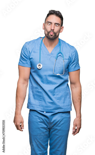 Wallpaper Mural Handsome young doctor surgeon man over isolated background making fish face with lips, crazy and comical gesture. Funny expression. Torontodigital.ca