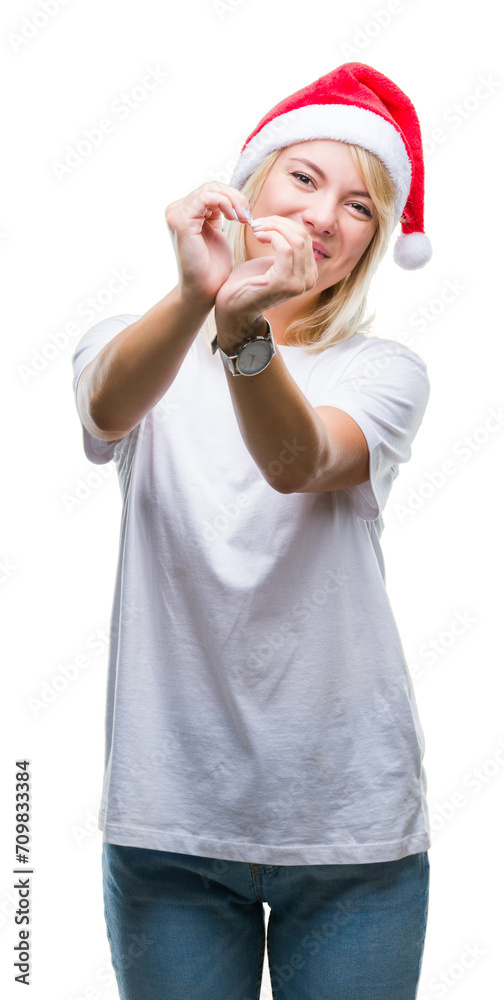 Young beautiful blonde woman wearing christmas hat over isolated background smiling in love showing heart symbol and shape with hands. Romantic concept. Young beautiful blonde woman wearing christmas hat over isolated background smiling in love showing heart symbol and shape with hands. Romantic concept.