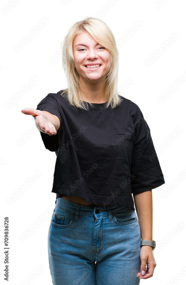 Young beautiful blonde woman over isolated background smiling friendly offering handshake as greeting and welcoming. Successful business. Young beautiful blonde woman over isolated background smiling friendly offering handshake as greeting and welcoming. Successful business.