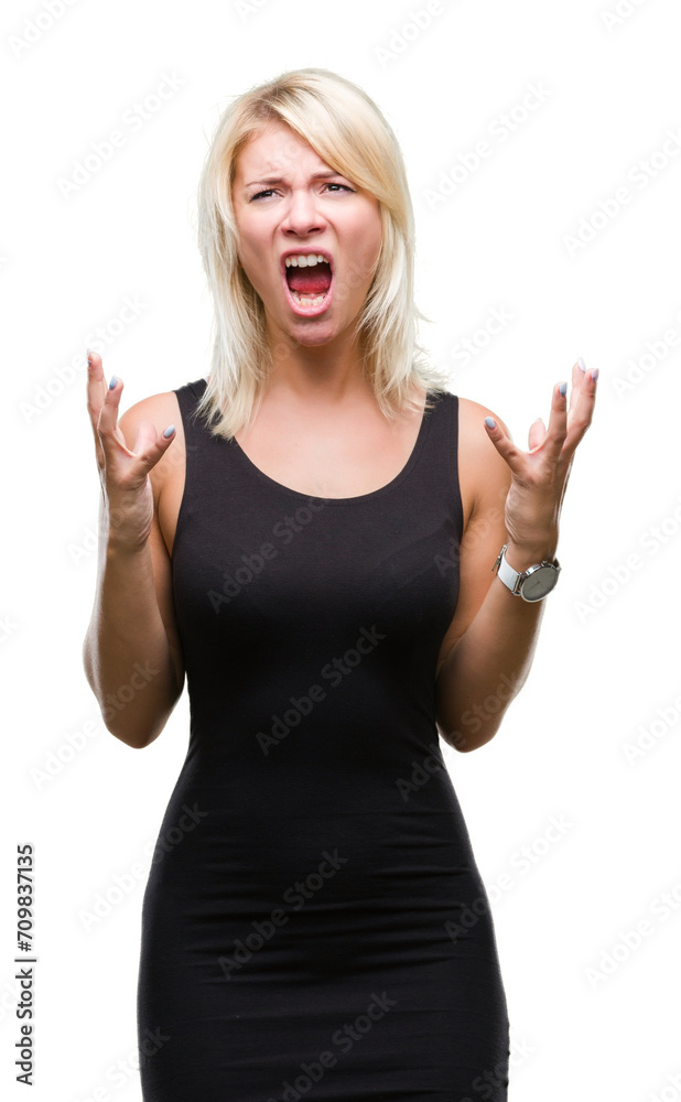 Young beautiful blonde attractive woman wearing elegant dress over isolated background crazy and mad shouting and yelling with aggressive expression and arms raised. Frustration concept. Young beautiful blonde attractive woman wearing elegant dress over isolated background crazy and mad shouting and yelling with aggressive expression and arms raised. Frustration concept.