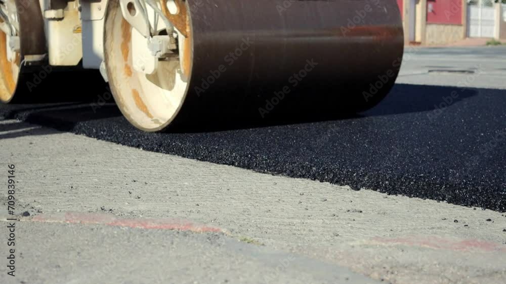 Road roller. The skating rink passes along the road. Road repair. Asphalt road. Close-up Road roller. The skating rink passes along the road. Road repair. Asphalt road. Close-up