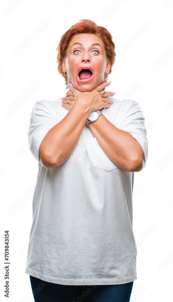 Atrractive senior caucasian redhead woman over isolated background shouting and suffocate because painful strangle. Health problem. Asphyxiate and suicide concept.