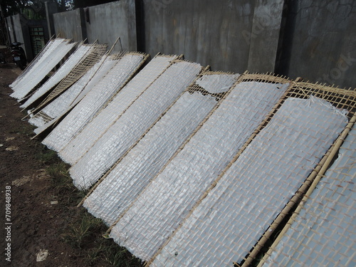 traditional way of rice noodles production in South East Asia, VIetnam,hand made noodles from rice flour are than drying outside on street on the sun on bamboo constructions,tasty delicious local food