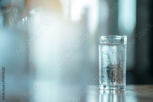 Water into a glass with ice.