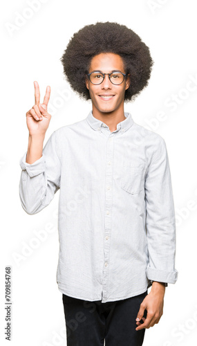 Young african american man with afro hair wearing glasses showing and pointing up with fingers number two while smiling confident and happy.